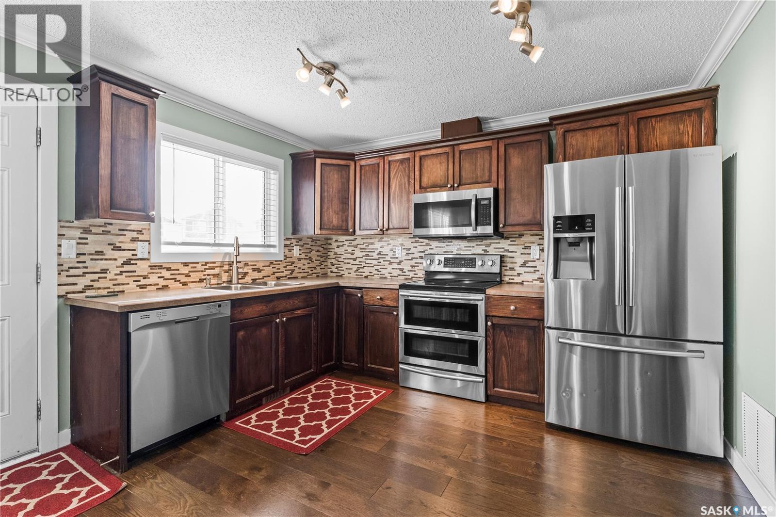 68 235 Rosewood Boulevard E, Saskatoon, SK - Indoor Photo Showing Kitchen With Double Sink With Upgraded Kitchen