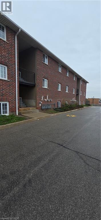 Multi-story brick building featuring multiple white-trimmed windows and individual balconies - 274 E Highland Road E Unit# 10, Kitchener, ON - Outdoor