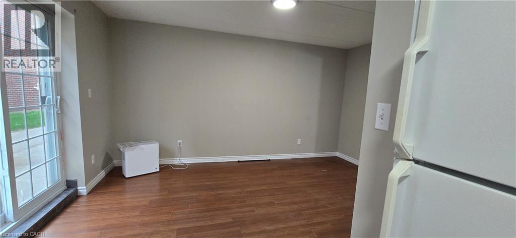 Room featuring wood-finish flooring, neutral wall tones, and white baseboards - 274 E Highland Road E Unit# 10, Kitchener, ON - Indoor Photo Showing Other Room