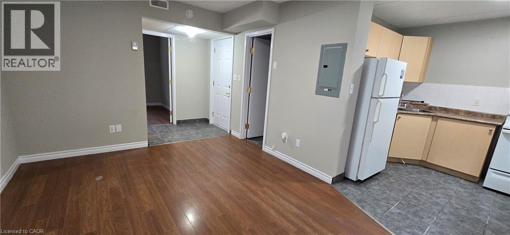 Open-concept living space featuring wood-finish flooring, light gray walls, and white trim - 274 E Highland Road E Unit# 10, Kitchener, ON - Indoor