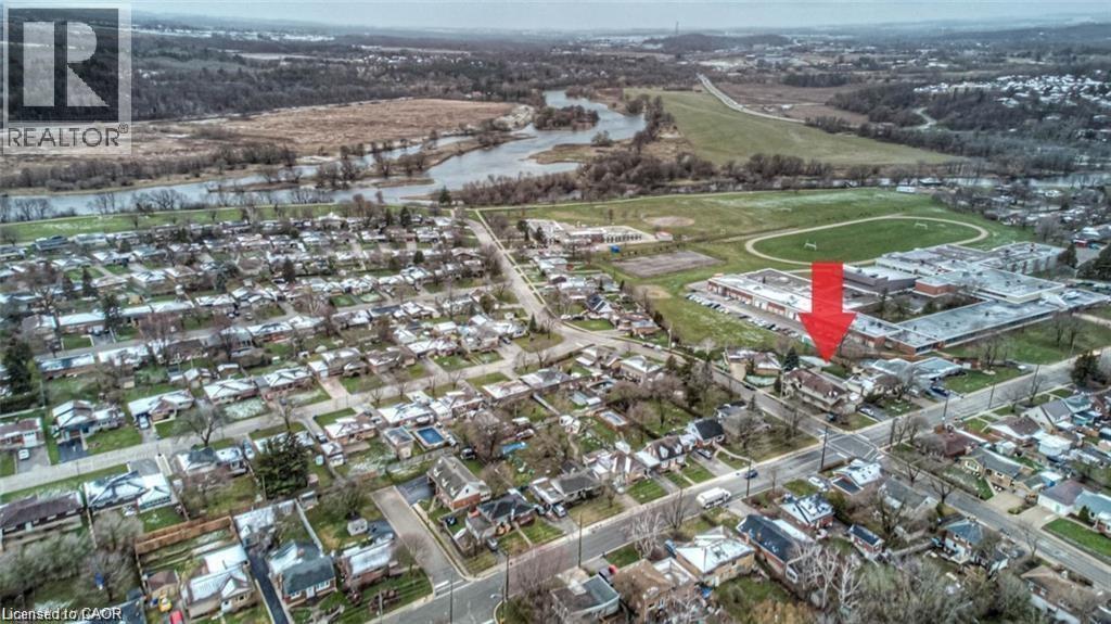 Aerial perspective showcasing a residential neighborhood with a river and natural landscape in the background - 716 Westminster Drive S Unit# Lower, Cambridge, ON - Outdoor With View