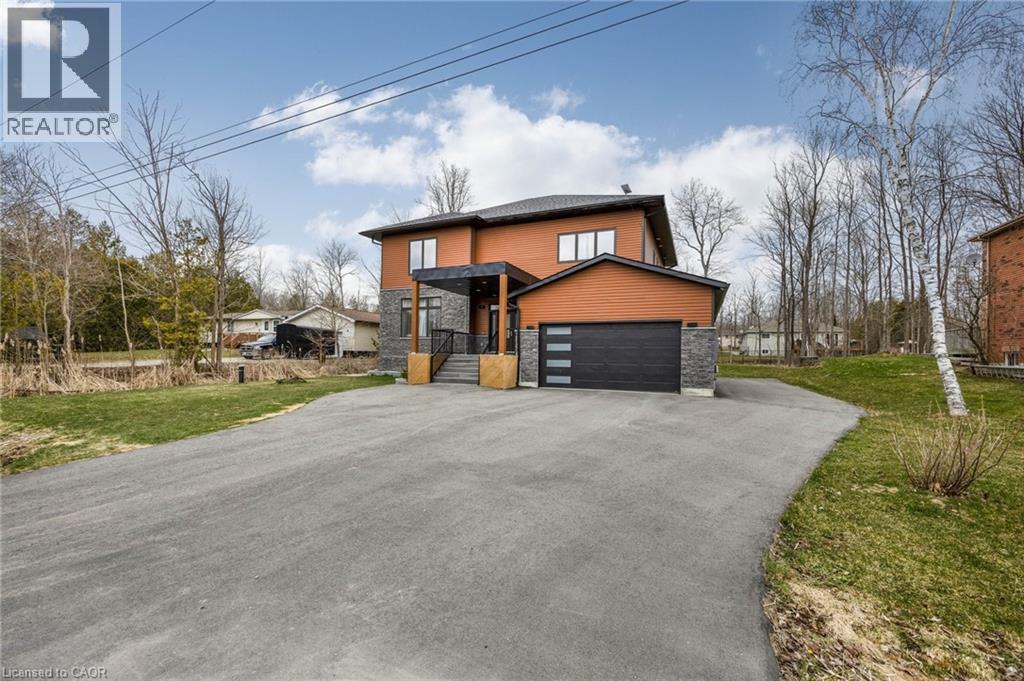 Contemporary two-story residence featuring a striking orange and brown exterior with stone accents - 6 Dorothys Drive, Oro-Medonte, ON - Outdoor
