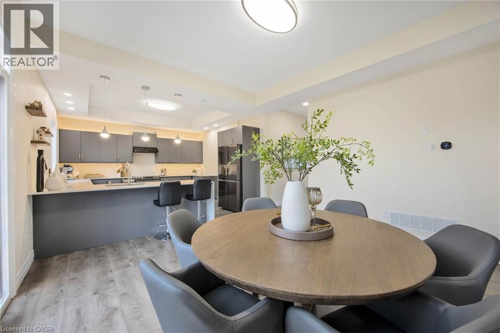 Open-concept kitchen and dining area featuring light wood-finish flooring, recessed lighting, and a kitchen island with seating - 6 Dorothys Drive, Oro-Medonte, ON - Indoor Photo Showing Dining Room