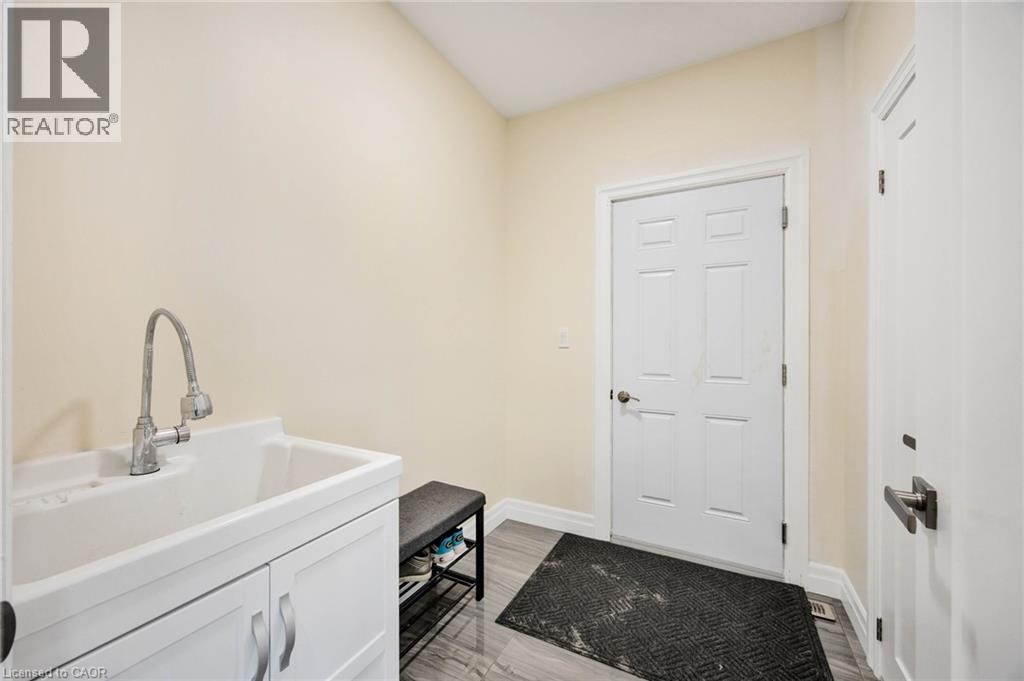 Utility sink with chrome gooseneck faucet and white cabinetry - 6 Dorothys Drive, Oro-Medonte, ON - Indoor