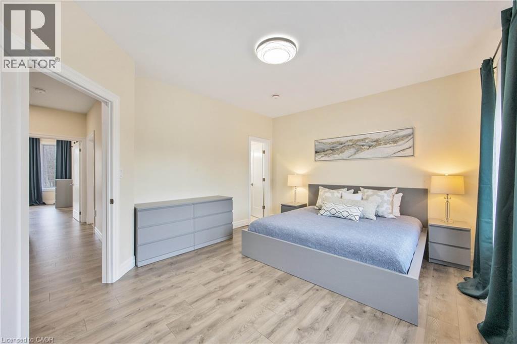 Spacious room featuring wood-finish flooring, a contemporary flush-mount ceiling light, and light-colored walls - 6 Dorothys Drive, Oro-Medonte, ON - Indoor Photo Showing Bedroom