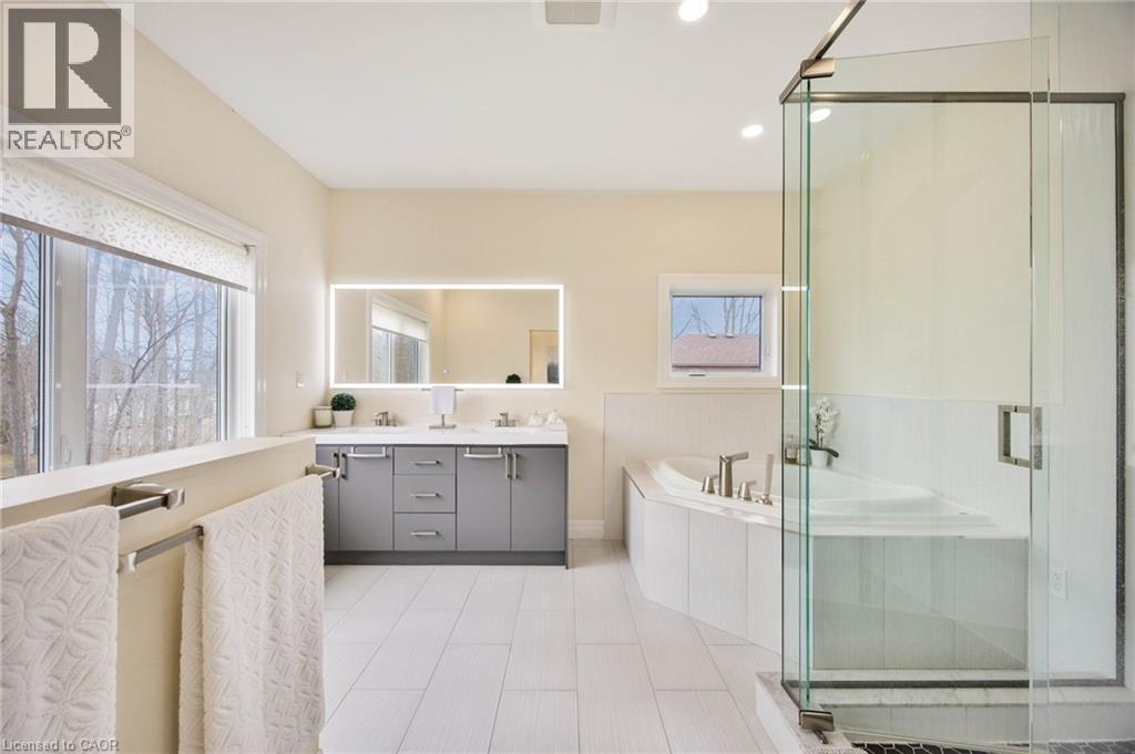 Spacious bathroom featuring a glass-enclosed shower, corner soaking tub, and a double vanity with an illuminated mirror - 6 Dorothys Drive, Oro-Medonte, ON - Indoor Photo Showing Bathroom