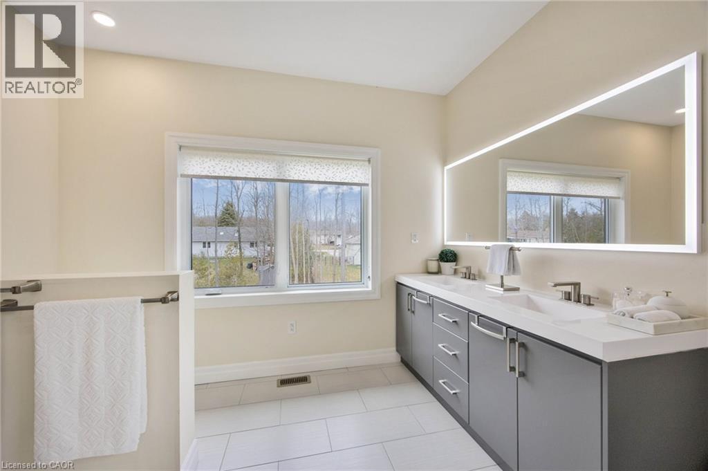 Modern bathroom featuring a double vanity with gray cabinetry and white countertops - 6 Dorothys Drive, Oro-Medonte, ON - Indoor