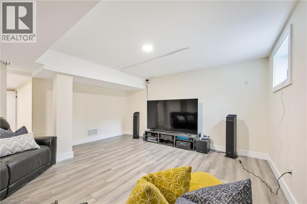 Spacious lower-level room featuring light wood-finish flooring, recessed lighting, and a neutral color palette - 6 Dorothys Drive, Oro-Medonte, ON - Indoor