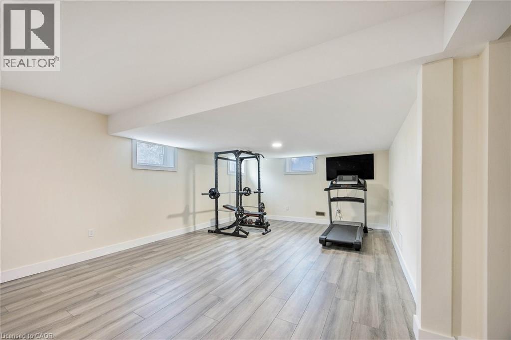 Spacious room featuring light wood-finish flooring, recessed lighting, and bright white baseboards - 6 Dorothys Drive, Oro-Medonte, ON - Indoor