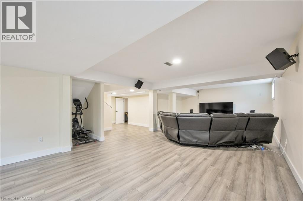 Spacious finished basement featuring light wood-finish flooring, recessed lighting, and white trim - 6 Dorothys Drive, Oro-Medonte, ON - Indoor
