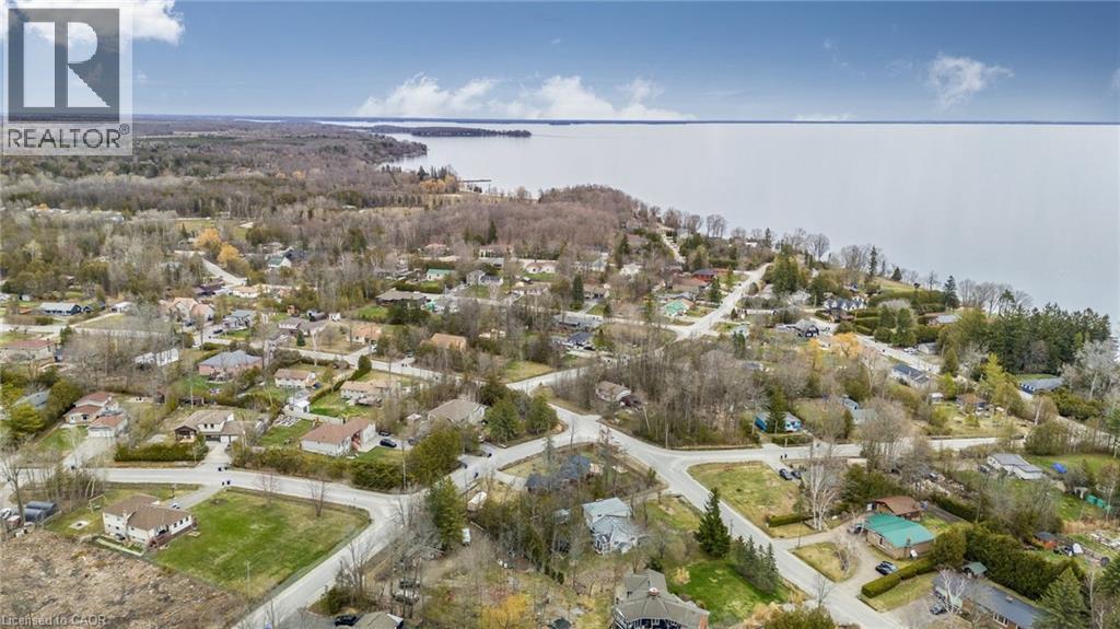 Aerial perspective showcasing a residential community with abundant mature trees and varied architectural styles - 6 Dorothys Drive, Oro-Medonte, ON - Outdoor With View