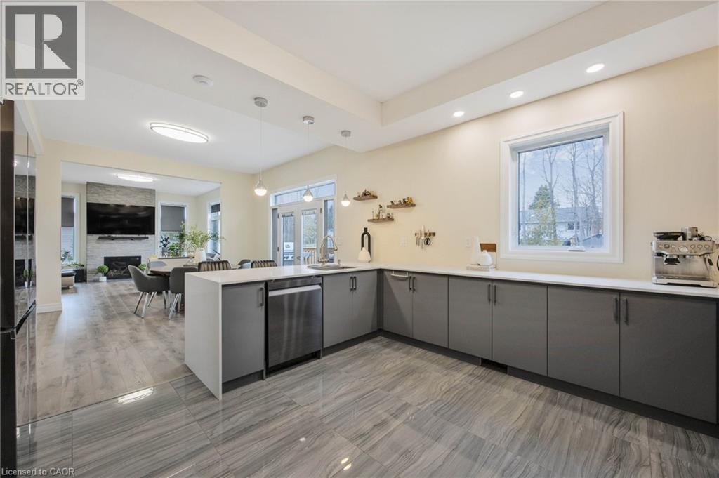 Expansive kitchen featuring wood-finish flooring, recessed lighting, and a large window - 6 Dorothys Drive, Oro-Medonte, ON - Indoor Photo Showing Kitchen