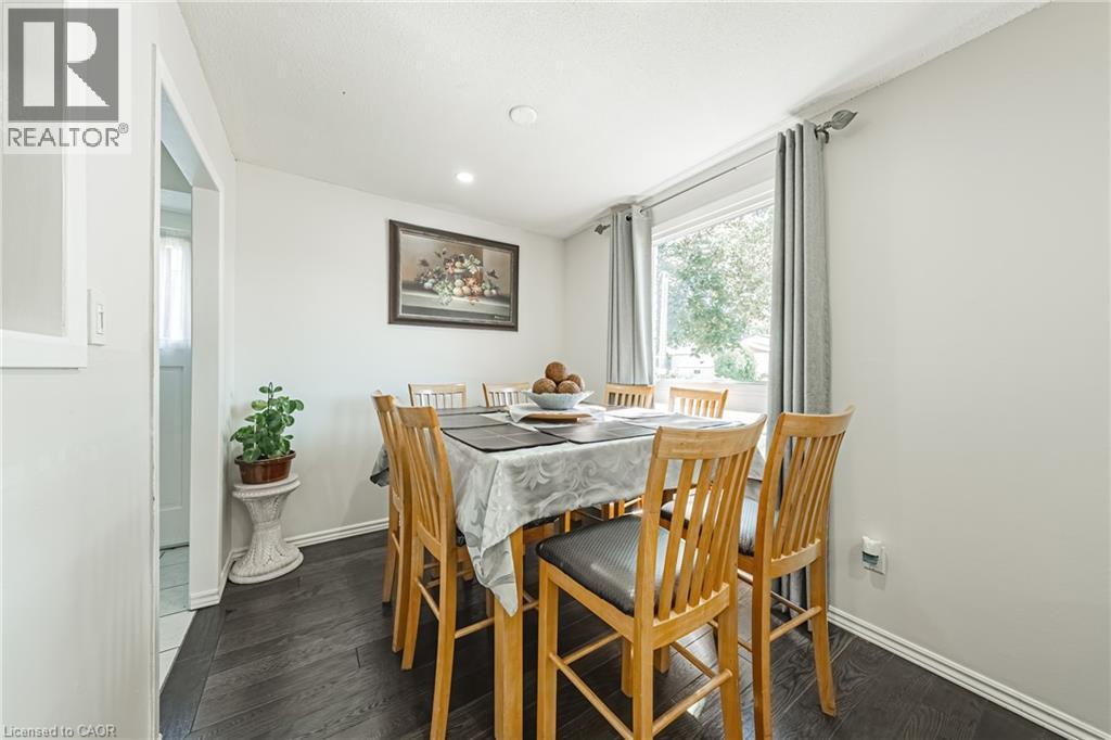 Dining area with dark wood-finish flooring and light-toned walls - 235 Larch Street, Hamilton, ON - Indoor Photo Showing Dining Room