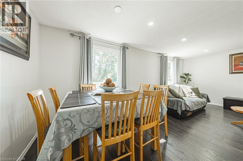 Open-concept living space with dark wood-finish flooring, recessed lighting, and neutral wall tones - 235 Larch Street, Hamilton, ON - Indoor Photo Showing Dining Room