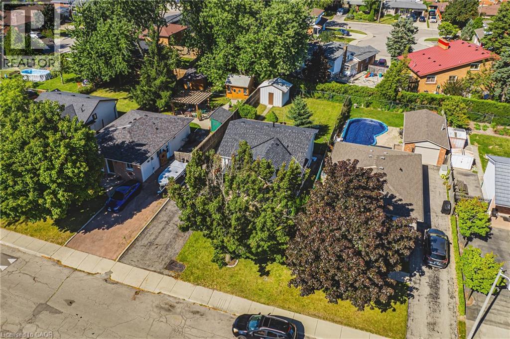 Aerial view showcasing a residential property with a dark shingle roof and a spacious backyard featuring a covered swimming pool - 235 Larch Street, Hamilton, ON - Outdoor With View