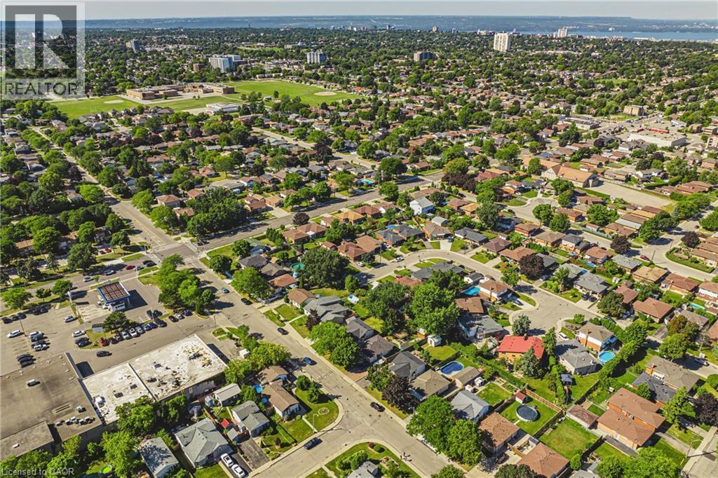 Aerial perspective showcasing a residential area with varied housing styles and mature tree coverage - 235 Larch Street, Hamilton, ON - Outdoor With View