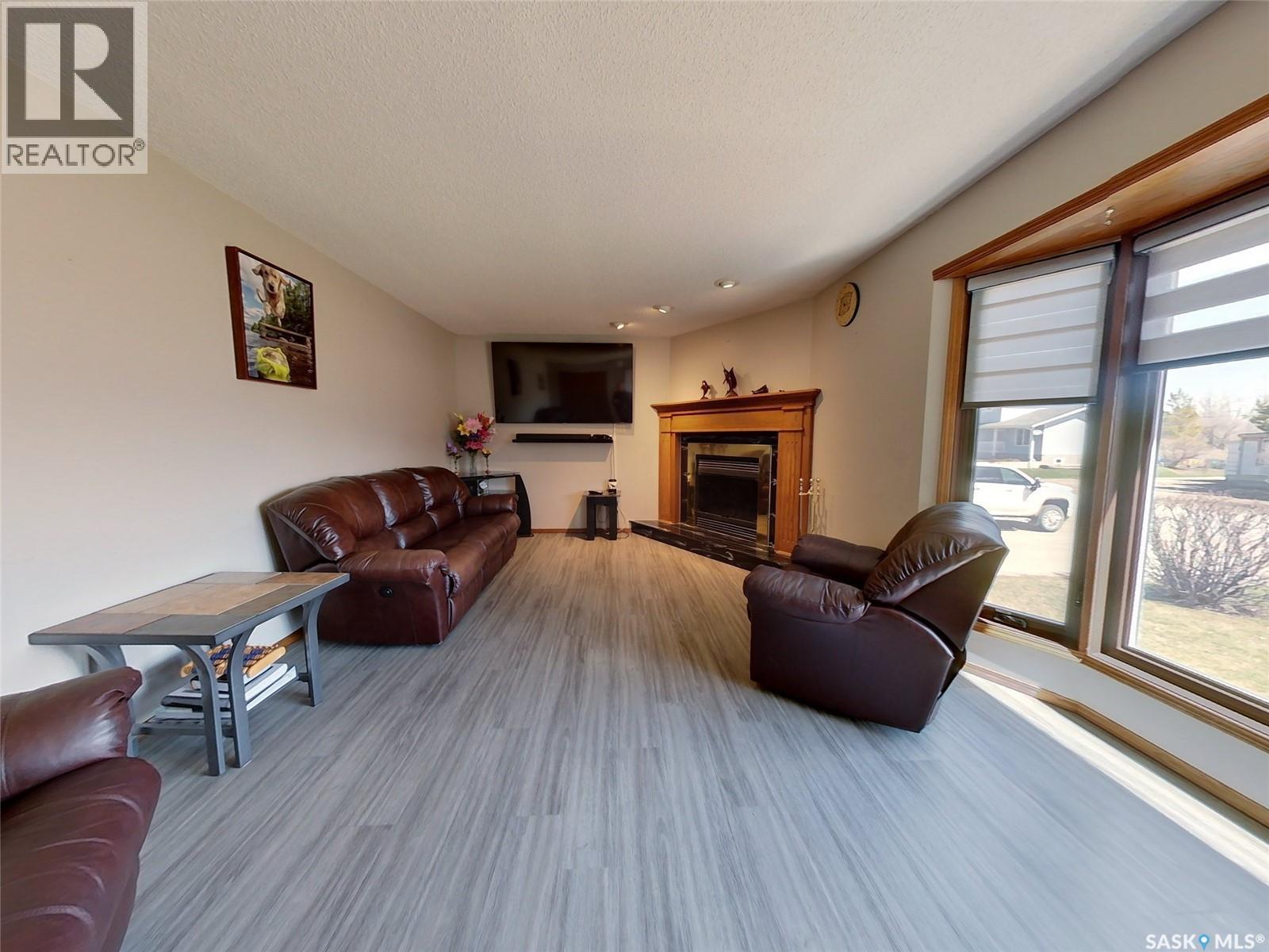 334 Young Street, Earl Grey, SK - Indoor Photo Showing Living Room With Fireplace
