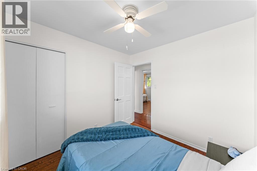 Interior room featuring wood-finish flooring and a ceiling fan with integrated lighting - 183 Harvard Road, Waterloo, ON - Indoor Photo Showing Bedroom