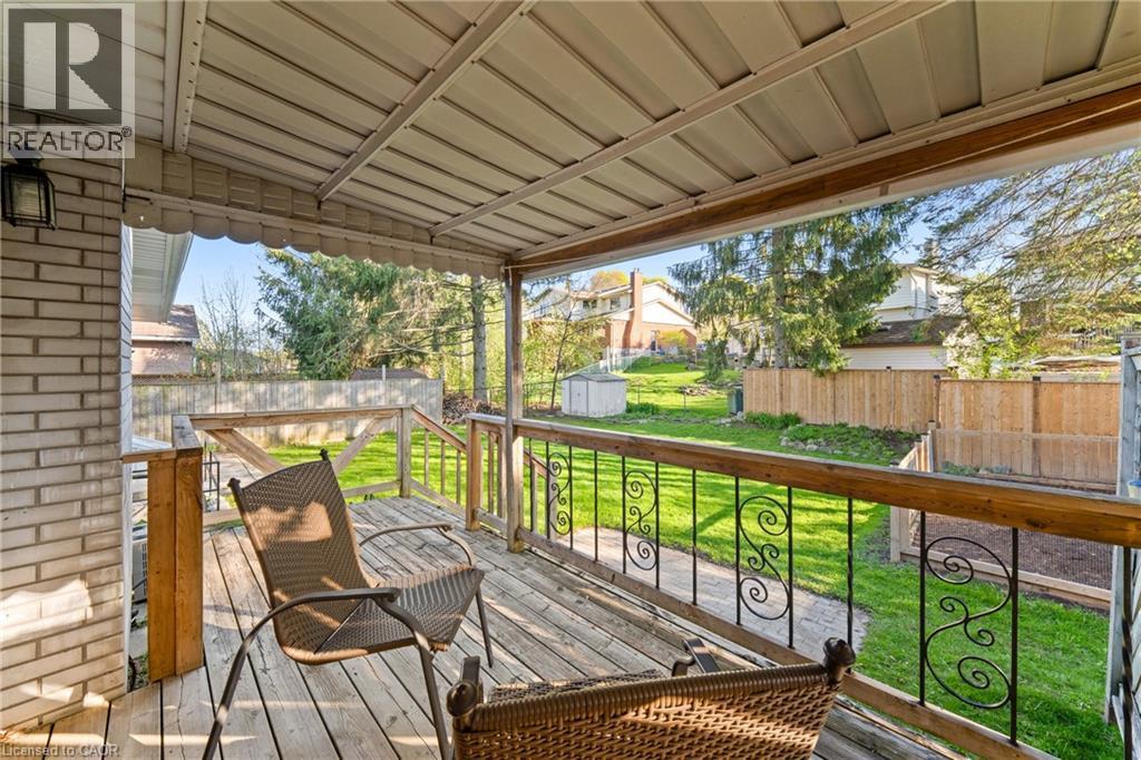 Covered outdoor deck with wood-finish flooring and an ornate metal railing - 183 Harvard Road, Waterloo, ON - Outdoor With Deck Patio Veranda With Exterior