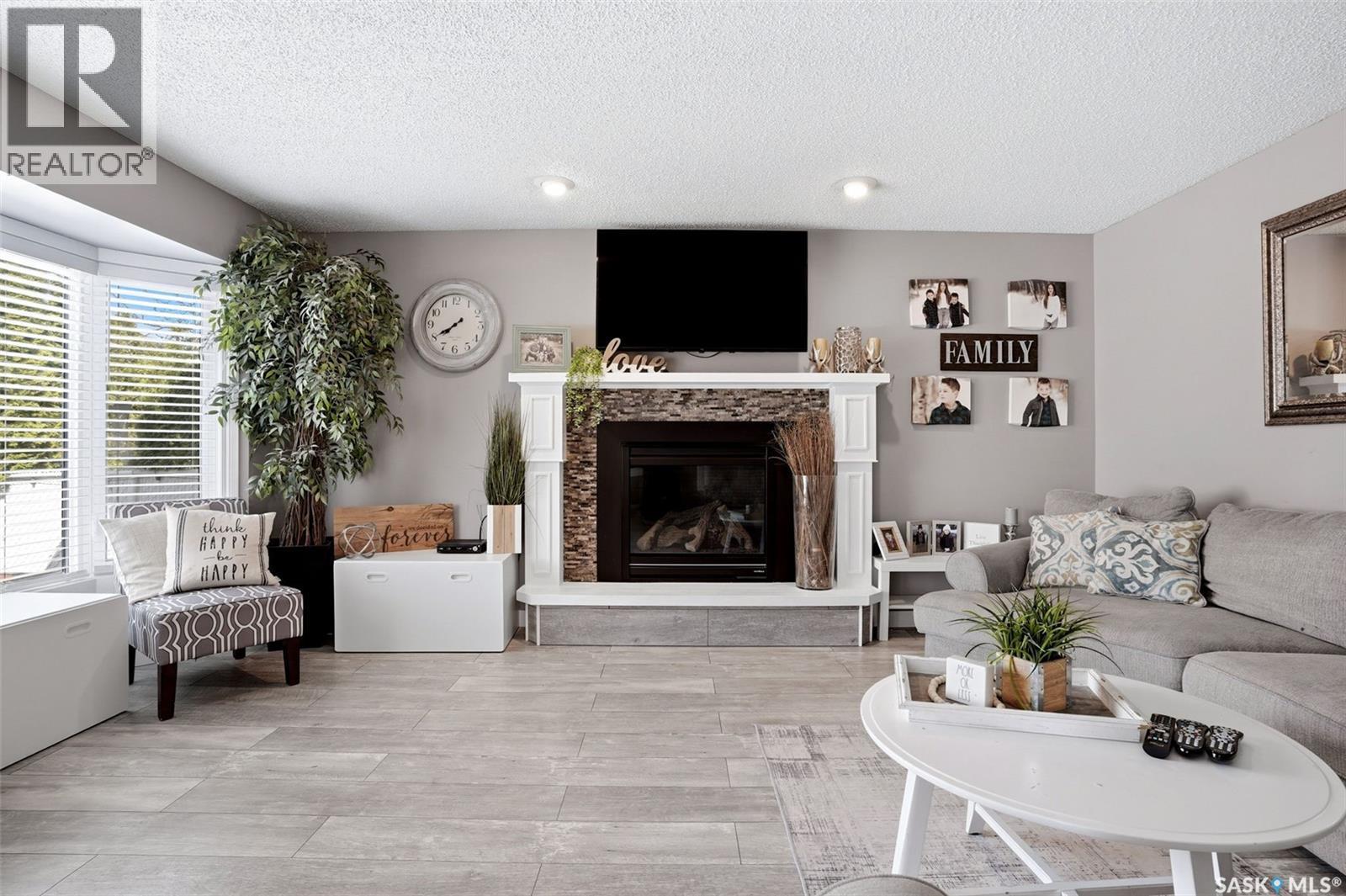 6954 Maple Brook Crescent, Regina, SK - Indoor Photo Showing Living Room With Fireplace