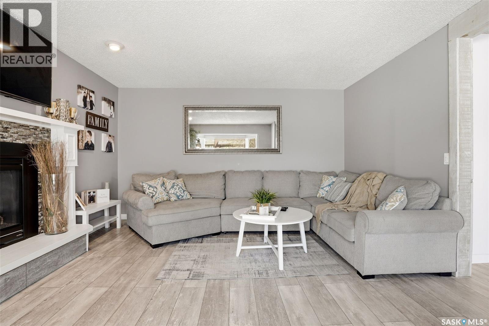 6954 Maple Brook Crescent, Regina, SK - Indoor Photo Showing Living Room With Fireplace