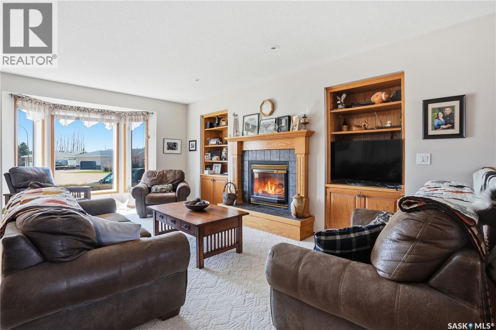 403 Willow Bay, Balgonie, SK - Indoor Photo Showing Living Room With Fireplace