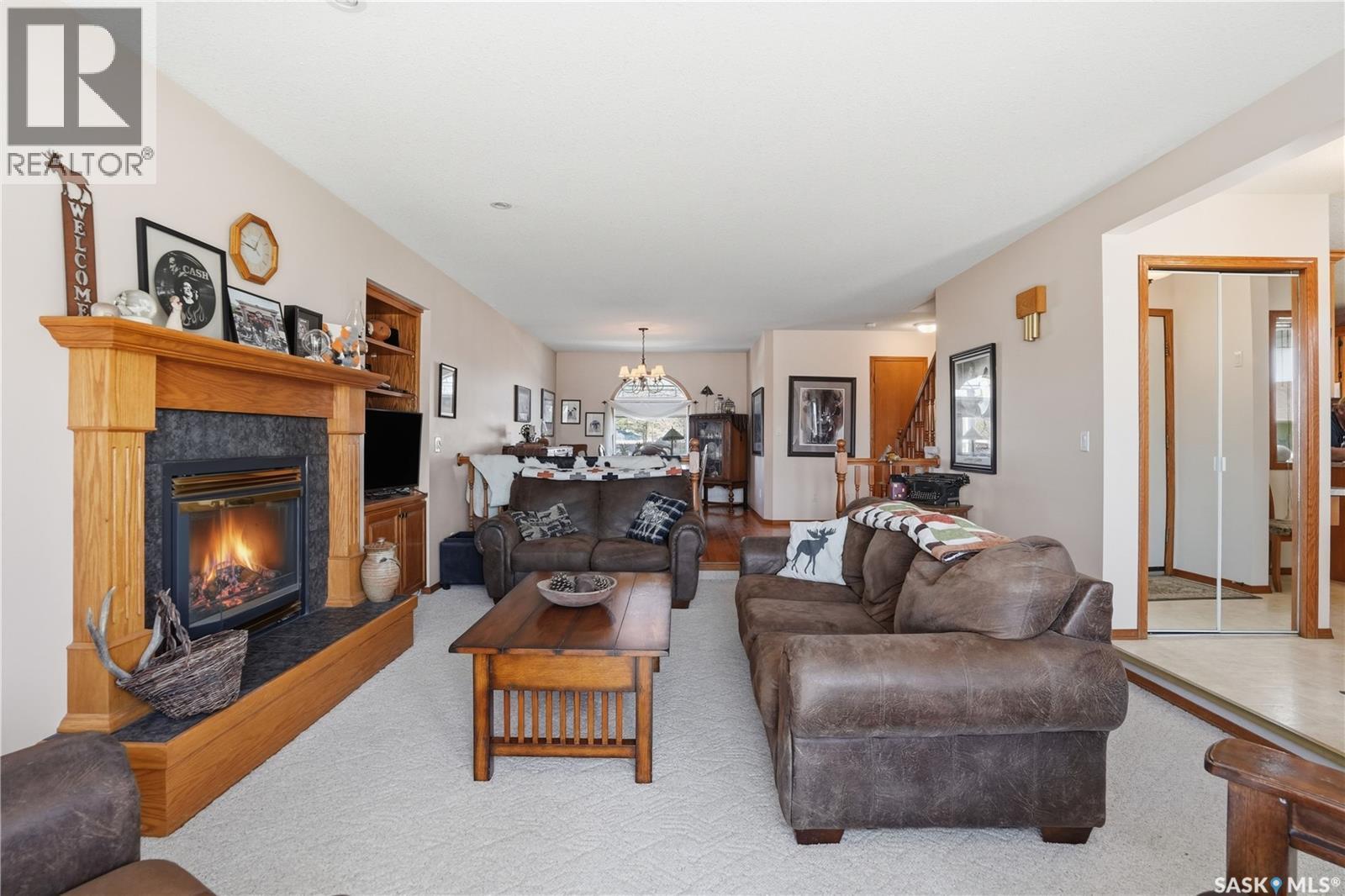 403 Willow Bay, Balgonie, SK - Indoor Photo Showing Living Room With Fireplace
