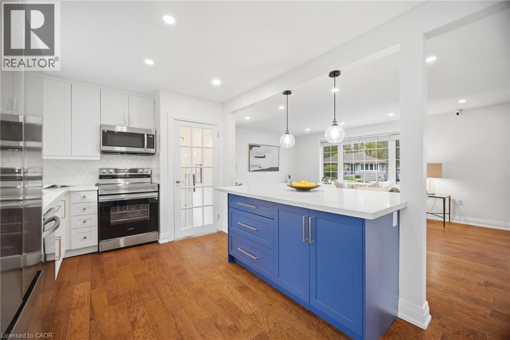 Kitchen featuring a blue island with a white countertop and pendant lighting - 1376 Royal Drive, Burlington, ON - Indoor Photo Showing Kitchen With Upgraded Kitchen