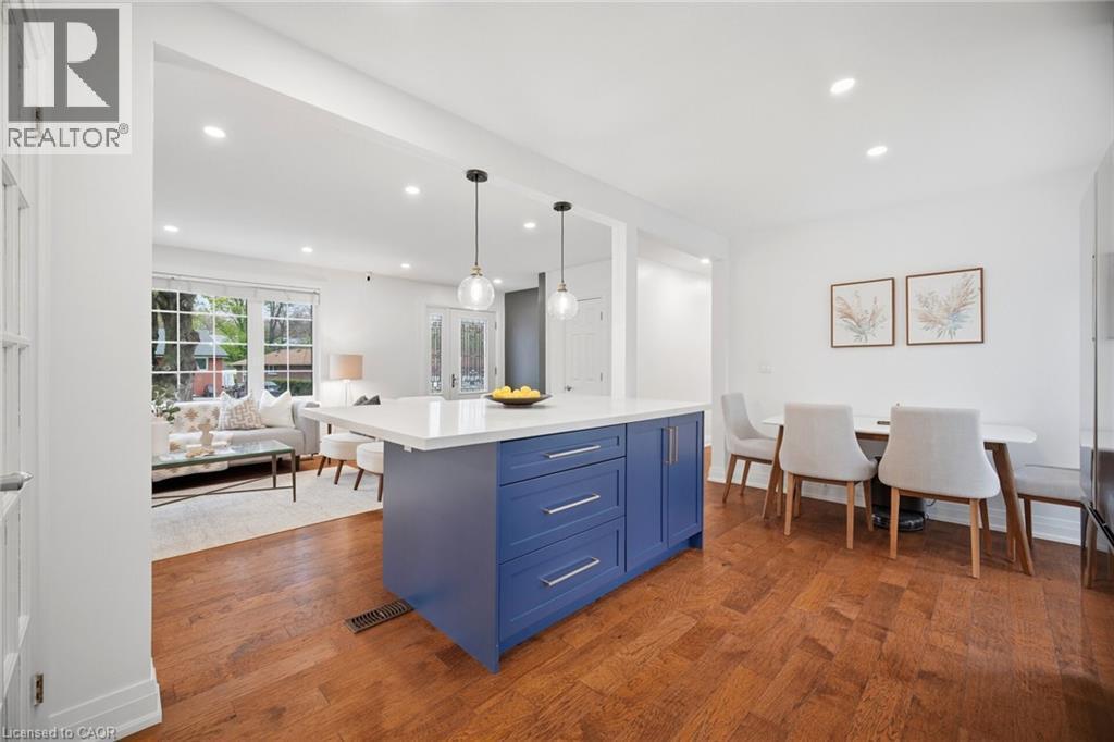 Kitchen island featuring a blue finish, integrated storage, and a white countertop - 1376 Royal Drive, Burlington, ON - Indoor