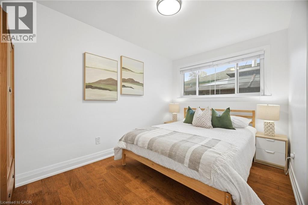 Bright room featuring wood-finish flooring, white walls, and a recessed window - 1376 Royal Drive, Burlington, ON - Indoor Photo Showing Bedroom
