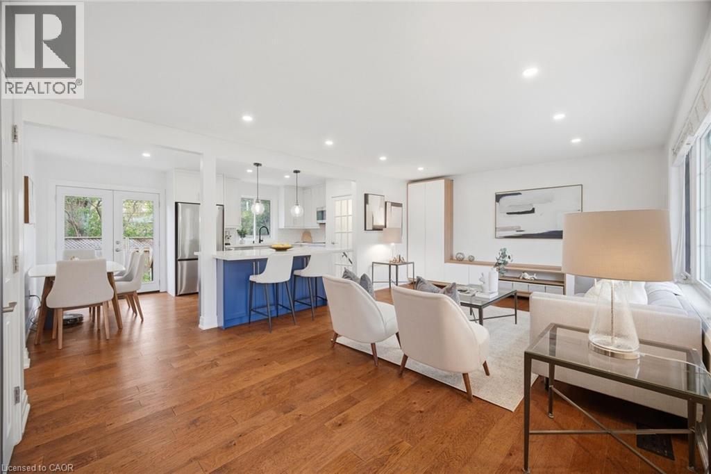 Open-concept living area with wood-finish flooring, recessed lighting, and white walls - 1376 Royal Drive, Burlington, ON - Indoor
