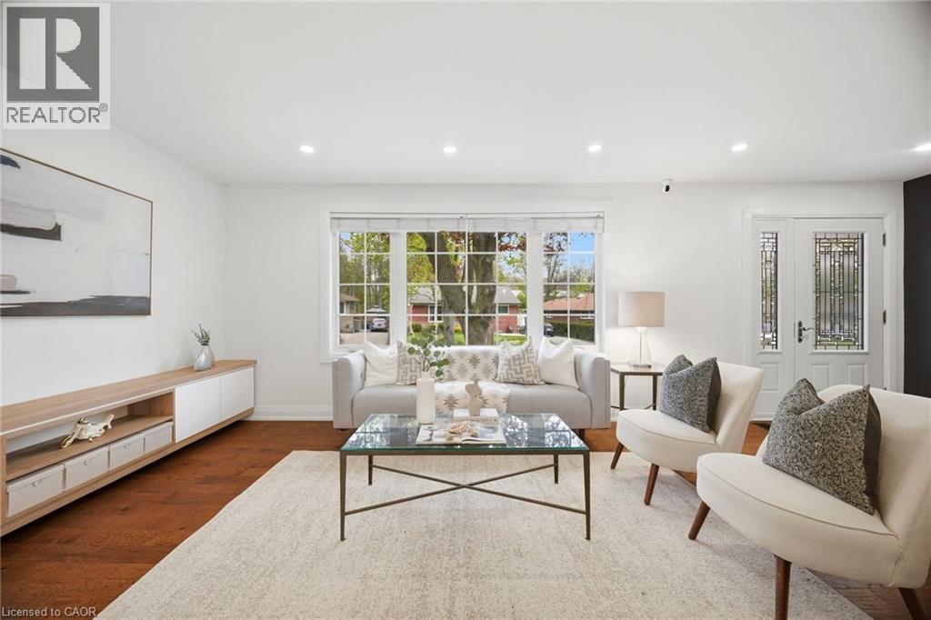 Bright living area with wood-finish flooring, recessed lighting, and a prominent bay window - 1376 Royal Drive, Burlington, ON - Indoor Photo Showing Living Room
