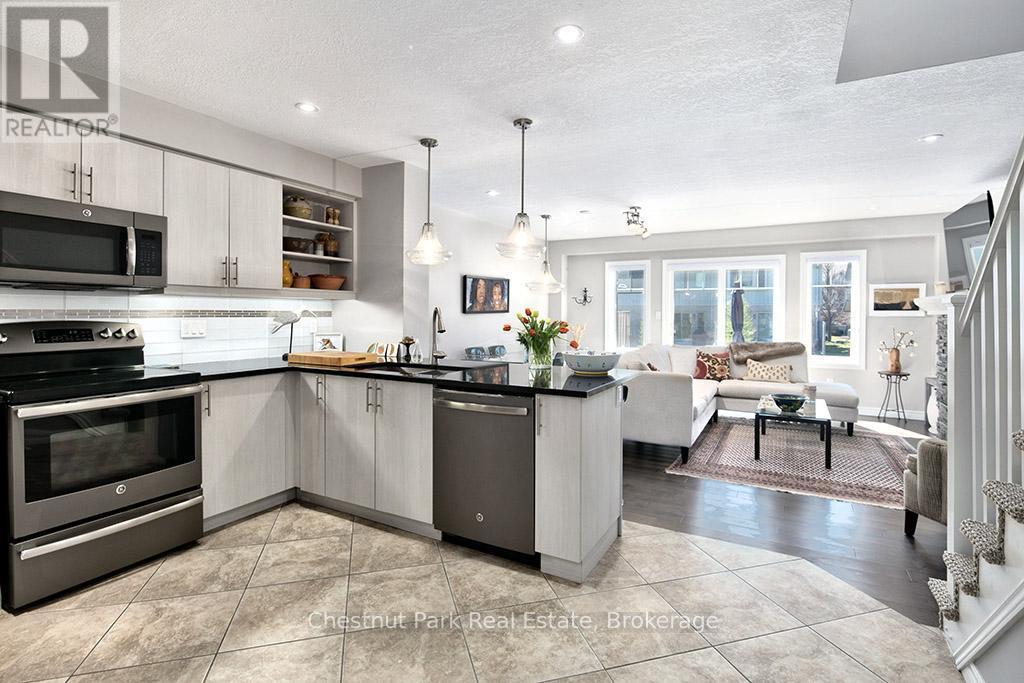 Open concept kitchen and living room - 54 Conservation Way, Collingwood, ON - Indoor Photo Showing Kitchen With Stainless Steel Kitchen With Upgraded Kitchen