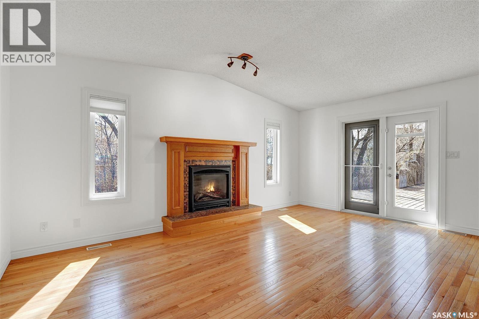 2419 Glamis Place E, Regina, SK - Indoor Photo Showing Living Room With Fireplace