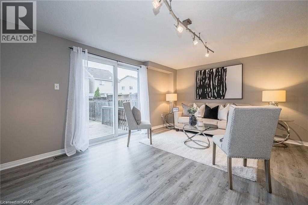 Living area featuring wood-finish flooring and neutral wall tones - 27 Max Becker Drive, Kitchener, ON - Indoor Photo Showing Living Room