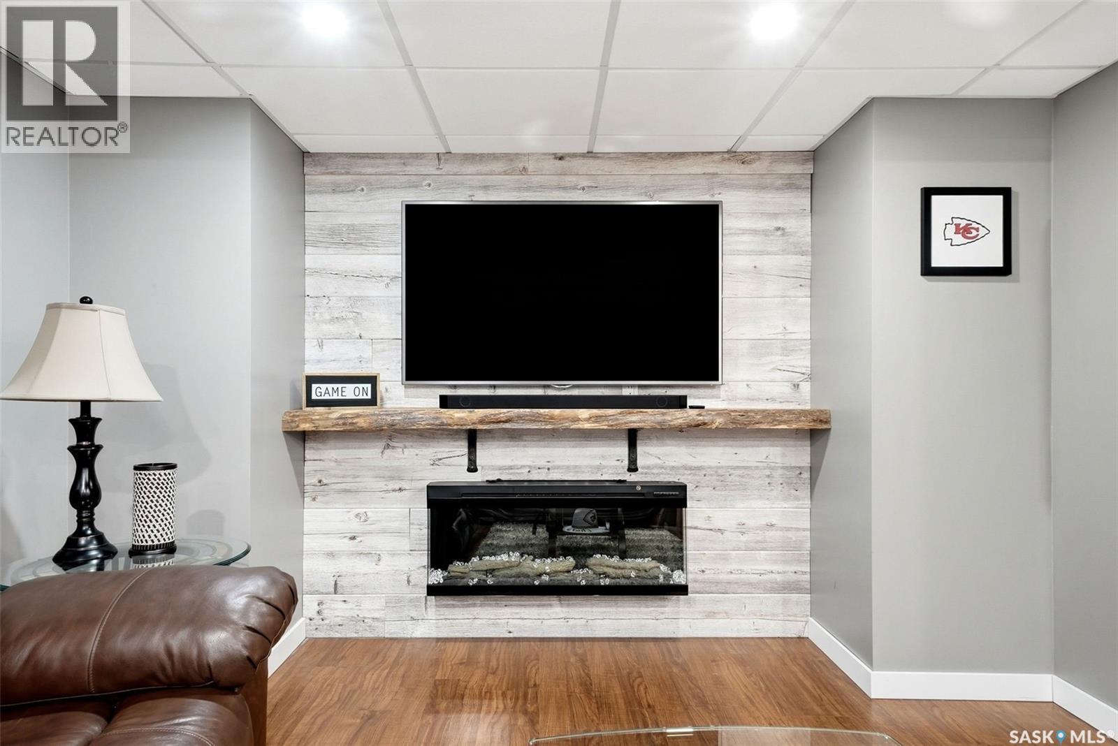 3234 Peyson Bay E, Regina, SK - Indoor Photo Showing Other Room With Fireplace