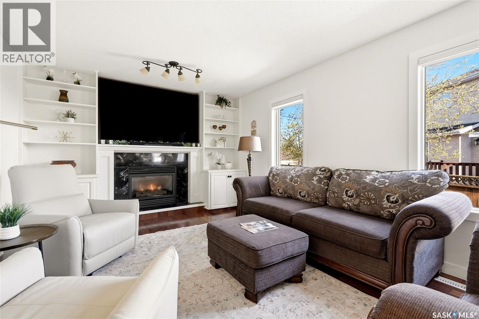 3234 Peyson Bay E, Regina, SK - Indoor Photo Showing Living Room With Fireplace