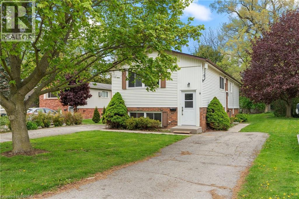 Split-level residence featuring white siding and brick detailing - 9 Cherry Street, Simcoe, ON - Outdoor