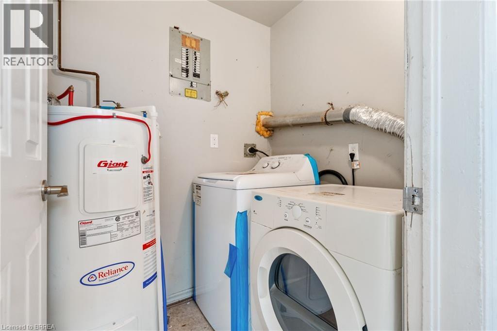 Dedicated utility space featuring a water heater, electrical panel, and dryer vent - 9 Cherry Street, Simcoe, ON - Indoor Photo Showing Laundry Room