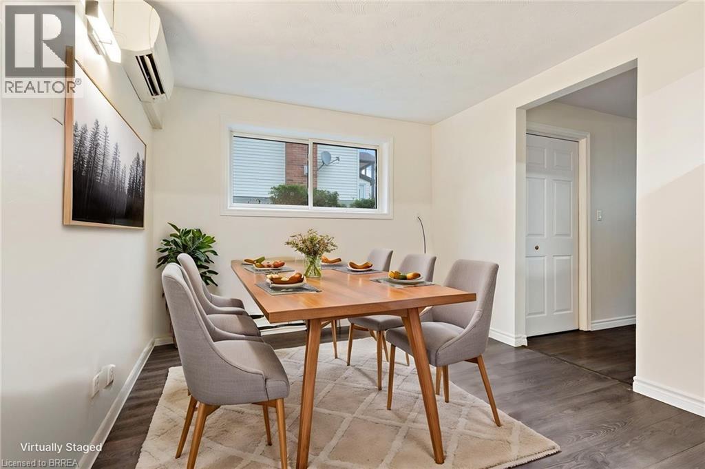 Dining area featuring hard surface flooring, white baseboards, and a window with blinds - 9 Cherry Street, Simcoe, ON - Indoor Photo Showing Dining Room