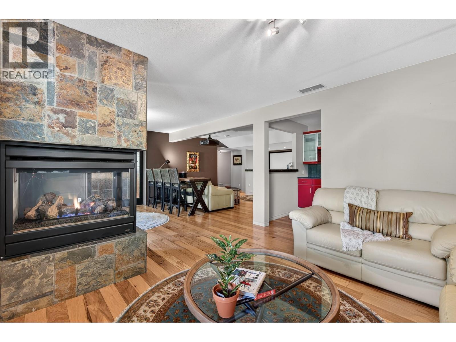 3929 Gallaghers Circle, Kelowna, BC - Indoor Photo Showing Living Room With Fireplace