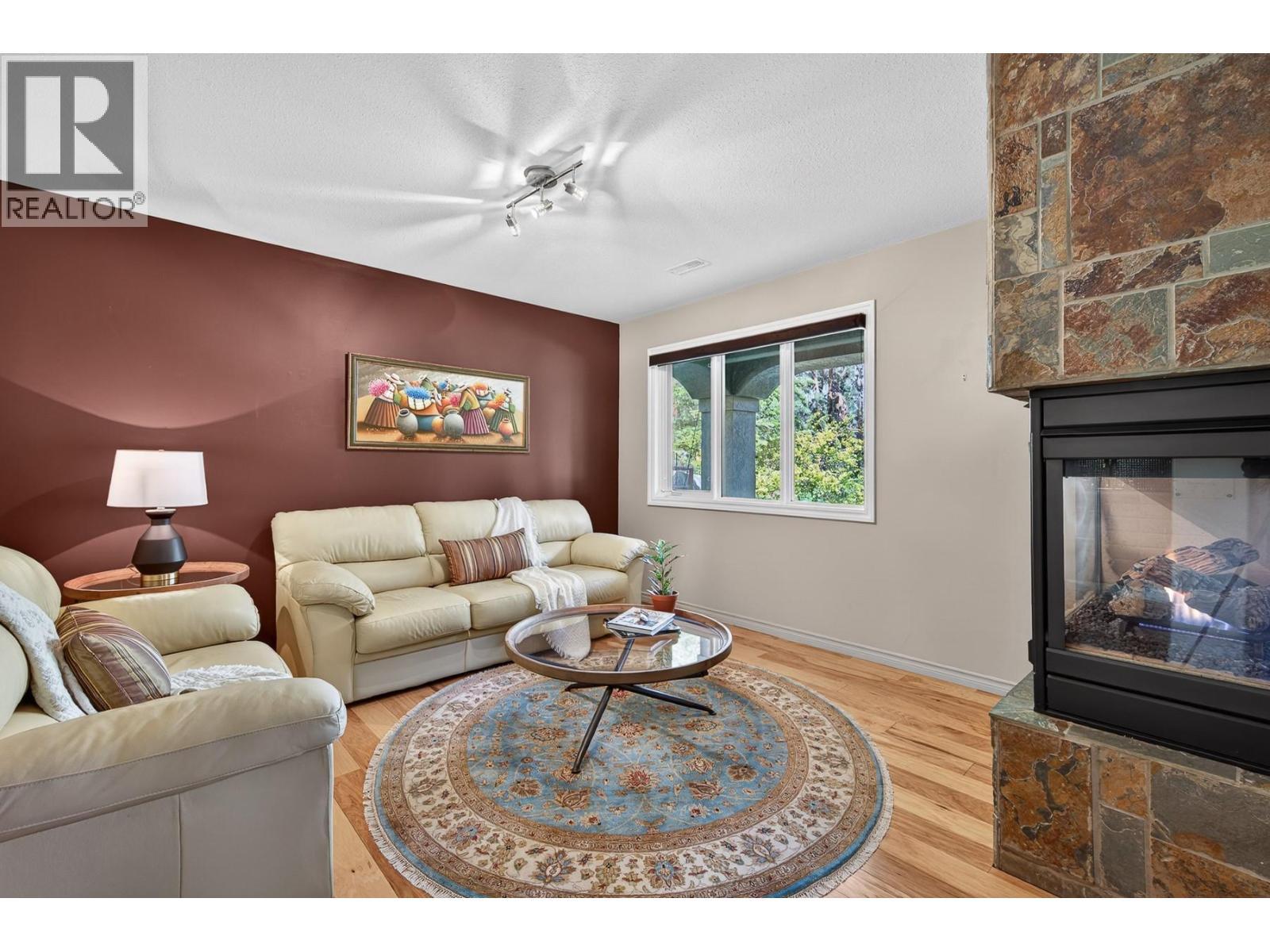 3929 Gallaghers Circle, Kelowna, BC - Indoor Photo Showing Living Room With Fireplace