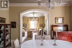 Archway entry to an additional room featuring a bay window -