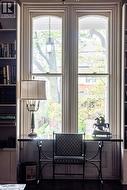 Tall arched windows with fluted trim detail -