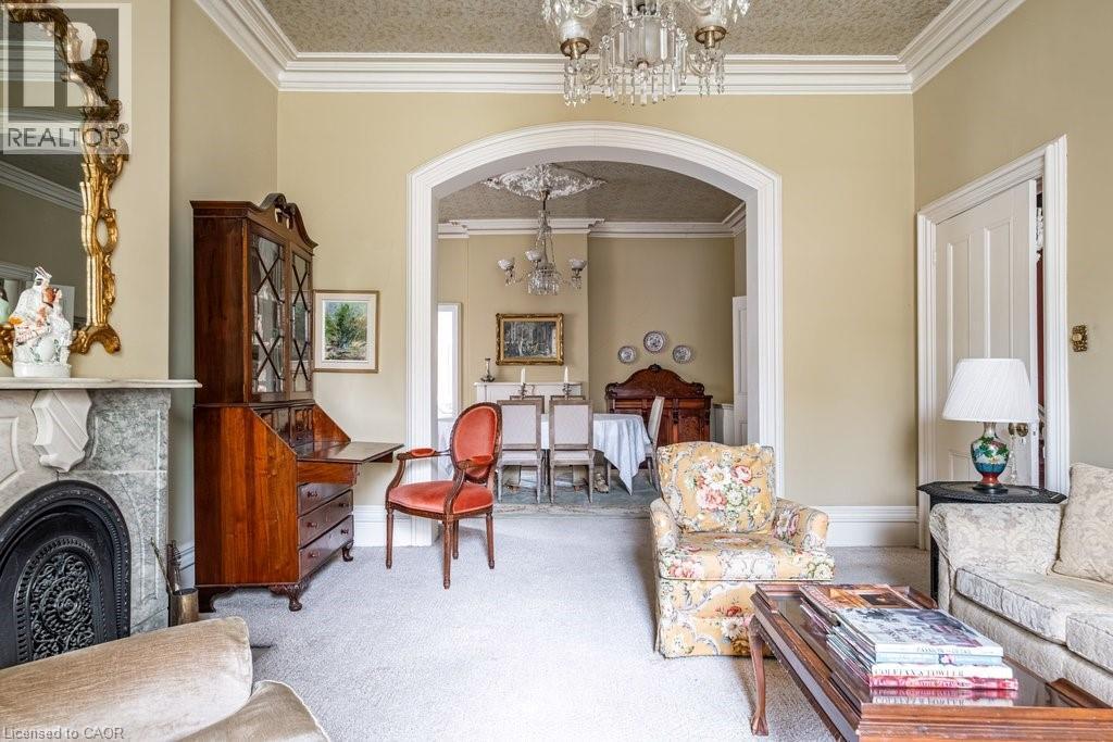 Elegant living space featuring a marble fireplace with an ornate mantel and cast iron firebox - 370 Hess Street S, Hamilton, ON - Indoor Photo Showing Living Room