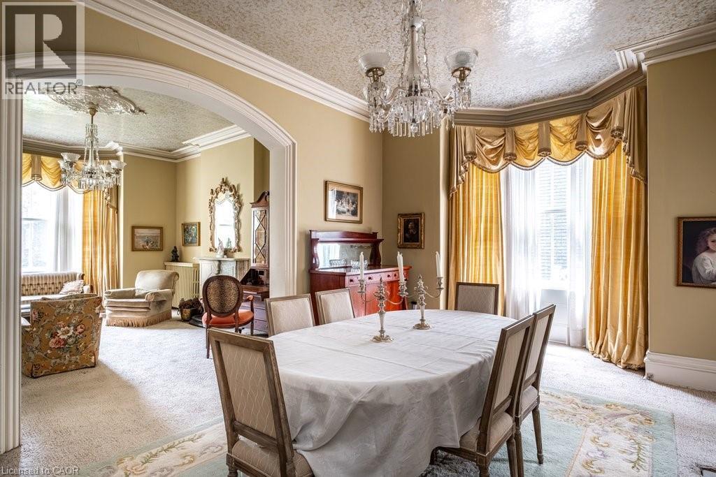 Formal dining area with an oval table and upholstered chairs - 370 Hess Street S, Hamilton, ON - Indoor Photo Showing Dining Room