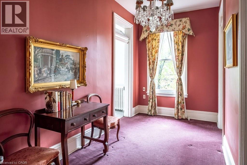 Formal room featuring a crystal chandelier, floral window treatments, and high ceilings - 370 Hess Street S, Hamilton, ON - Indoor Photo Showing Other Room