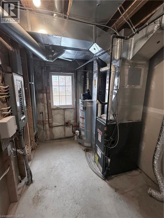 Utility room featuring a water heater, furnace unit, and visible ductwork - 50 Emick Drive, Ancaster, ON - Indoor Photo Showing Basement