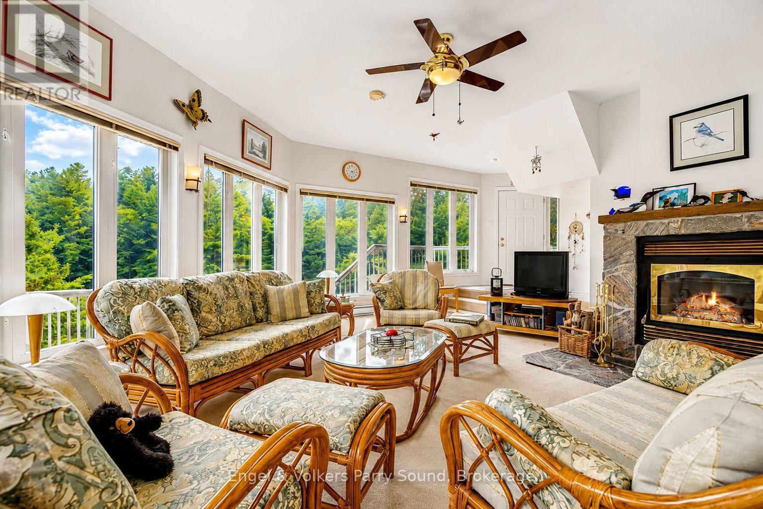 1 Loon Bay, Carling, ON - Indoor Photo Showing Living Room With Fireplace