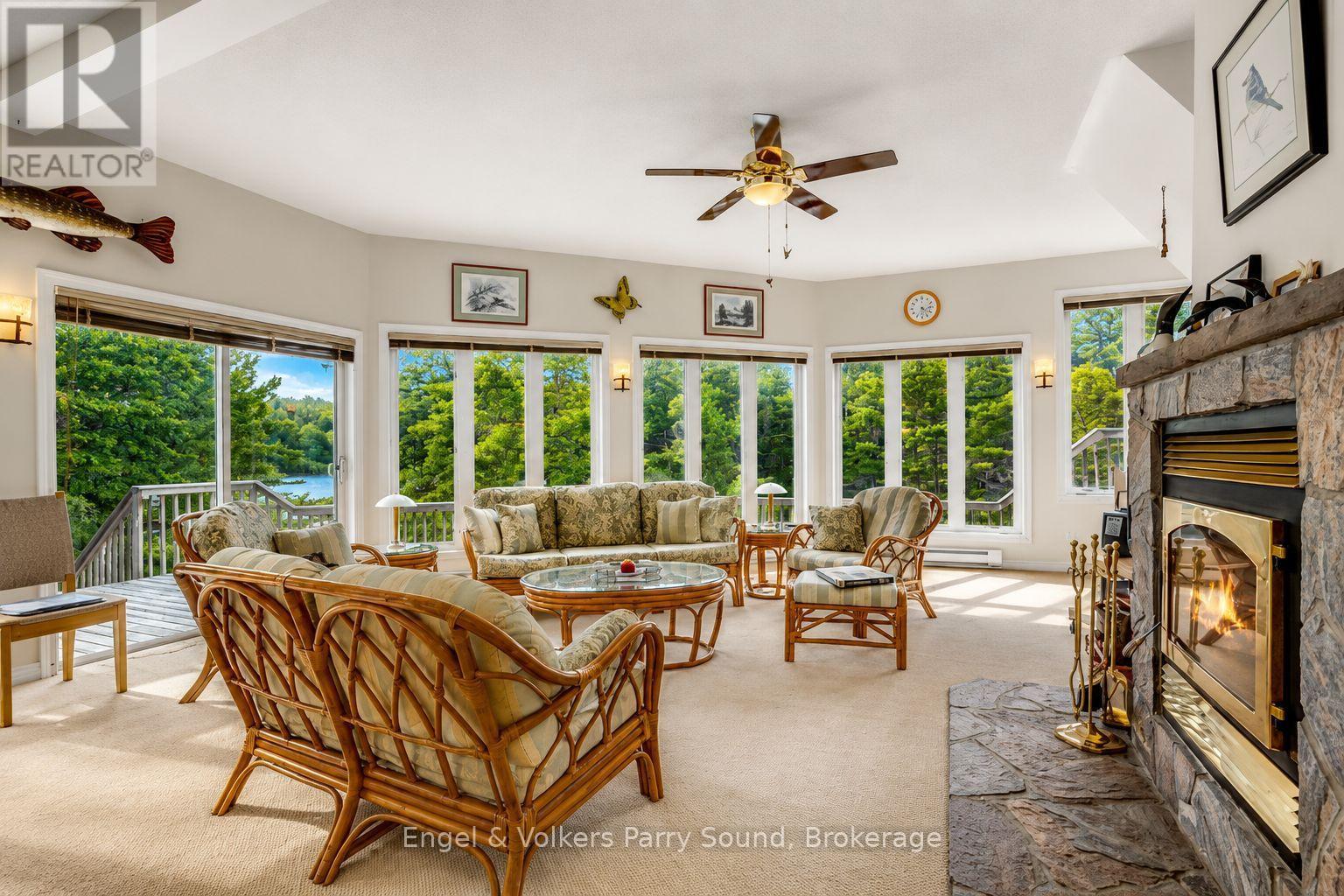 1 Loon Bay, Carling, ON - Indoor Photo Showing Living Room With Fireplace